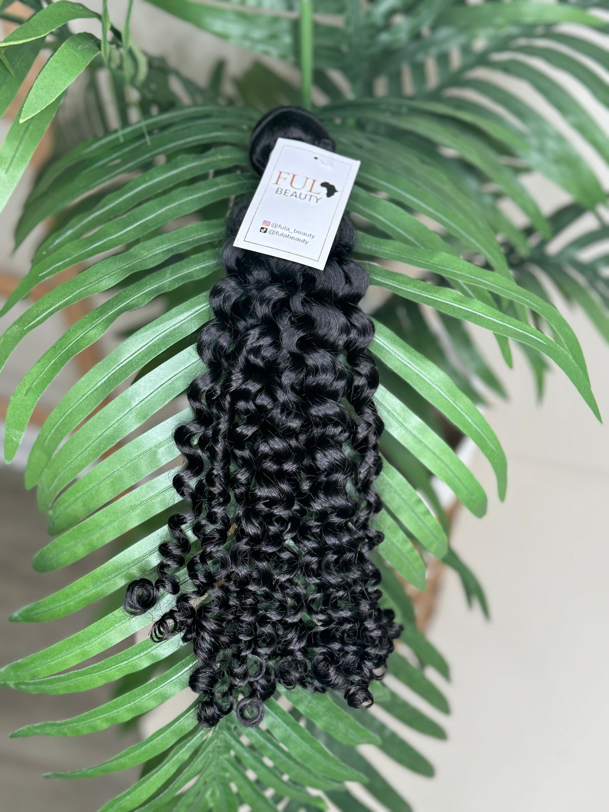 Italian curl wefted human hair bundle.